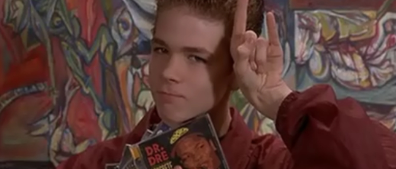 A kid holding Empire Records-released CDs